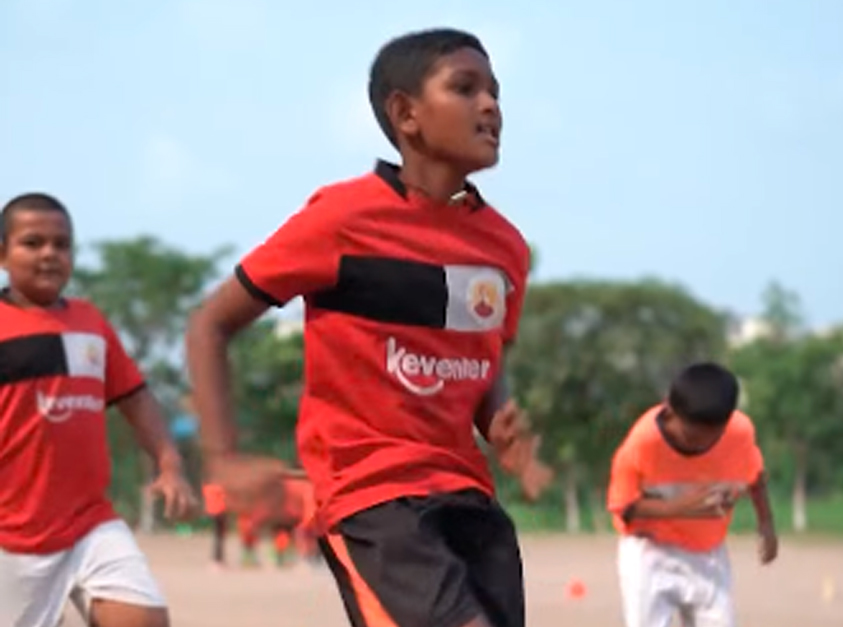 Young Keventer football players training on the field