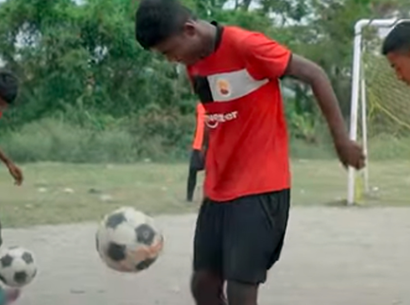 Young Keventer football players training on the field